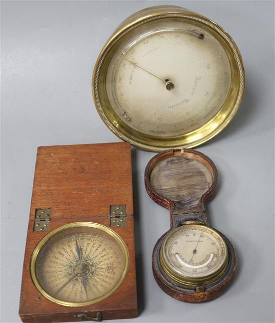 A Victorian brass cased aneroid barometer, a pocket barometer and a George III pocket compass